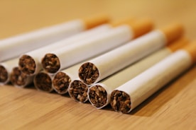 a group of cigarettes sitting on top of a wooden table