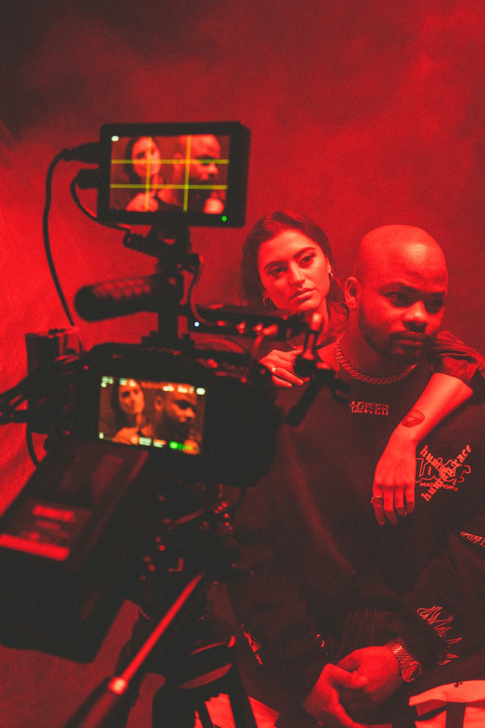 a man and a woman sitting in front of a camera