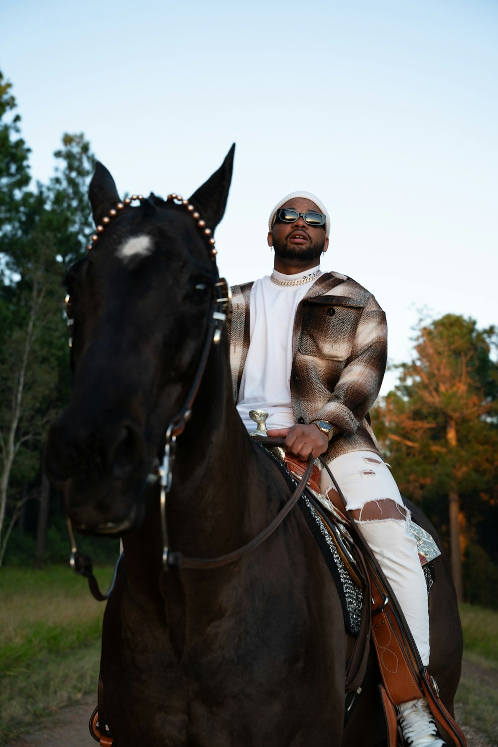 a man riding on the back of a brown horse