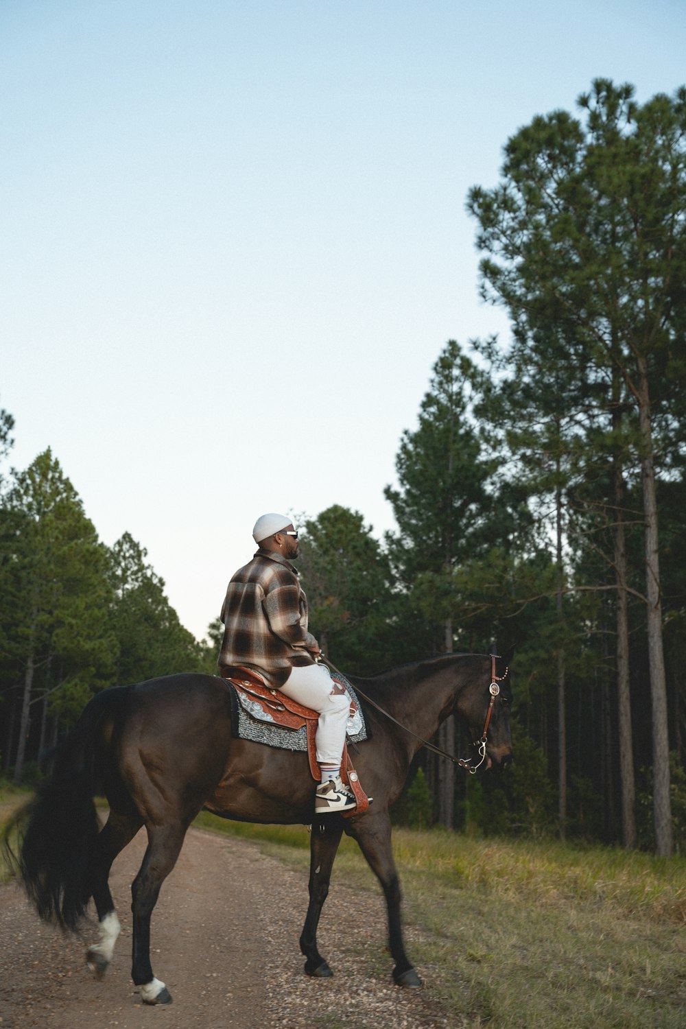 a man riding on the back of a brown horse