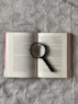 a book with a magnifying glass on top of it