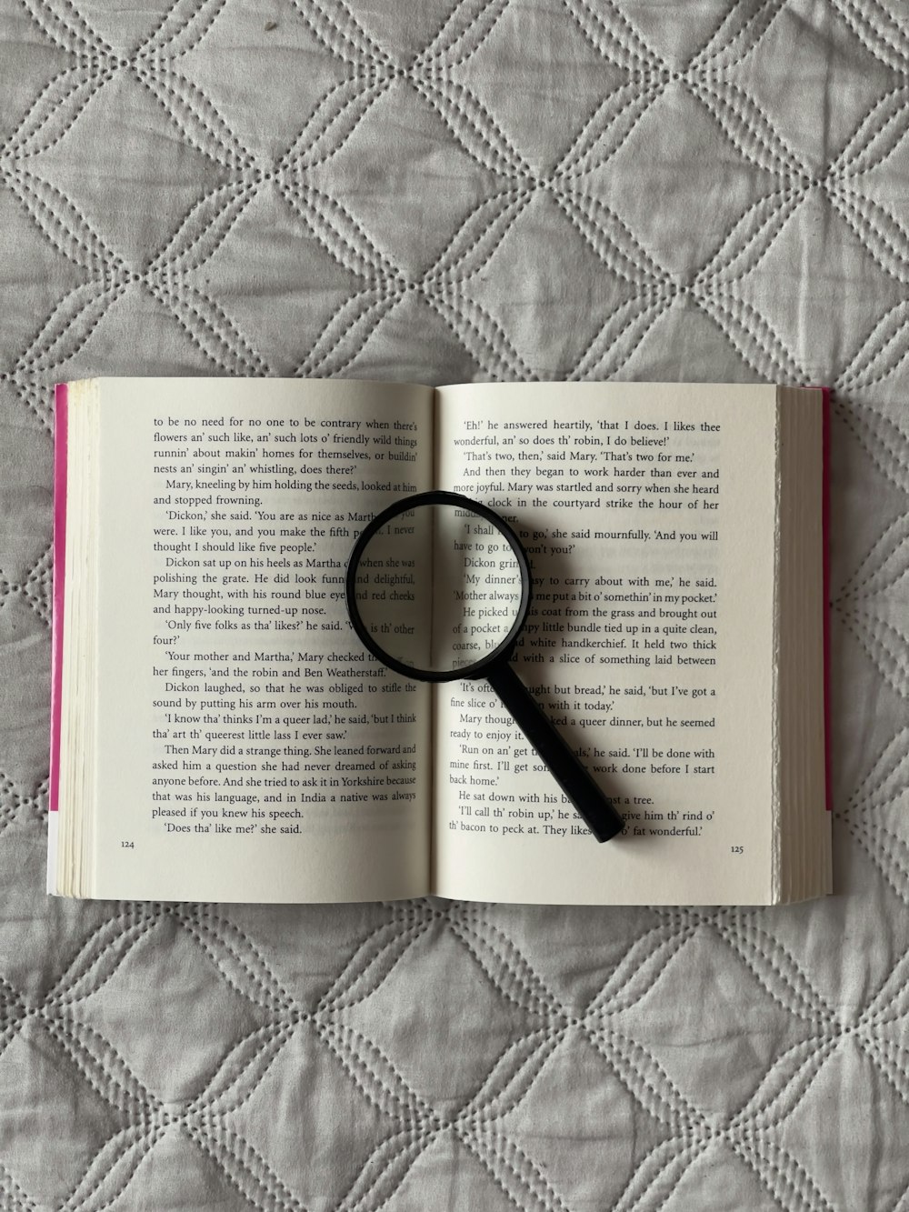 a book with a magnifying glass on top of it