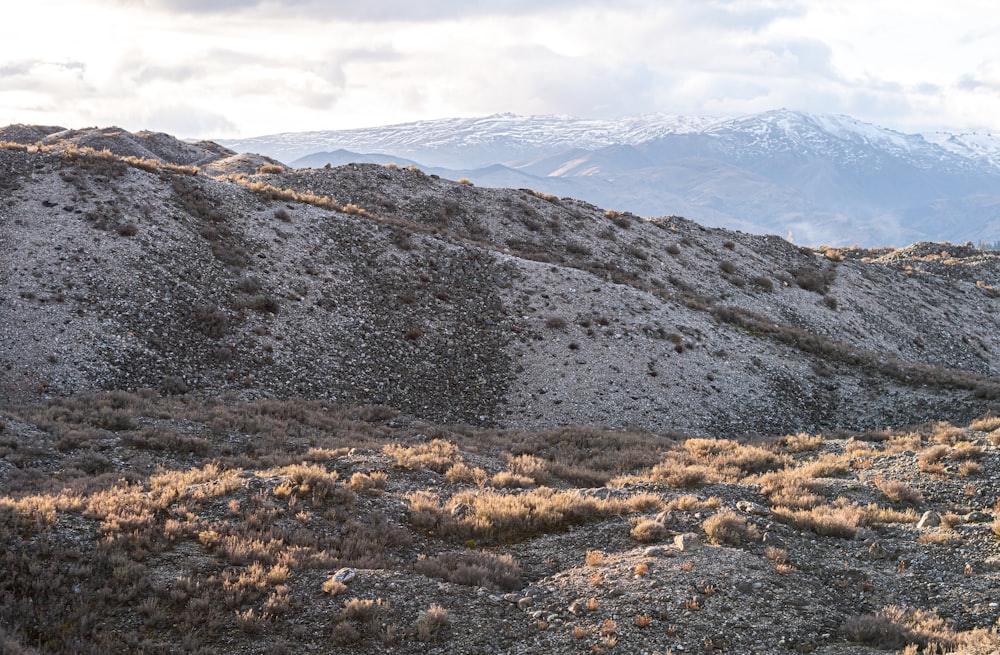 a mountain with a snow capped mountain in the distance