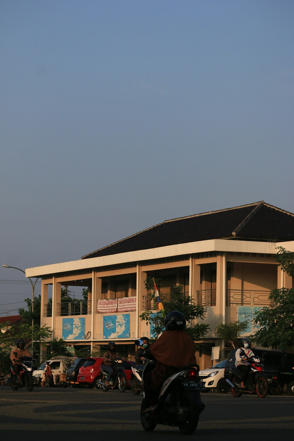 a person riding a motorcycle in front of a building