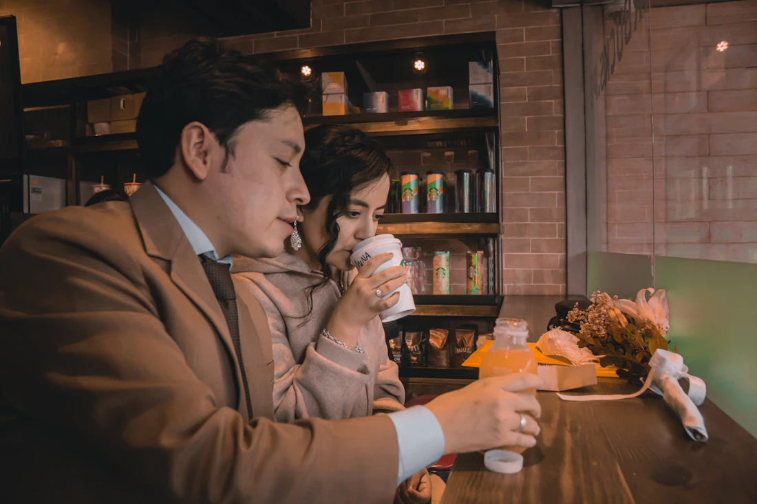 A man and a woman talking over coffee