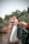 a bride and groom kissing on a bridge
