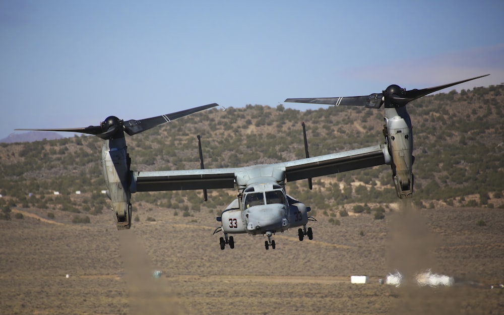 a large propeller plane flying over a field