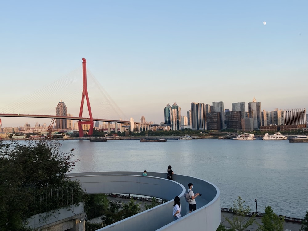 a group of people standing on top of a bridge