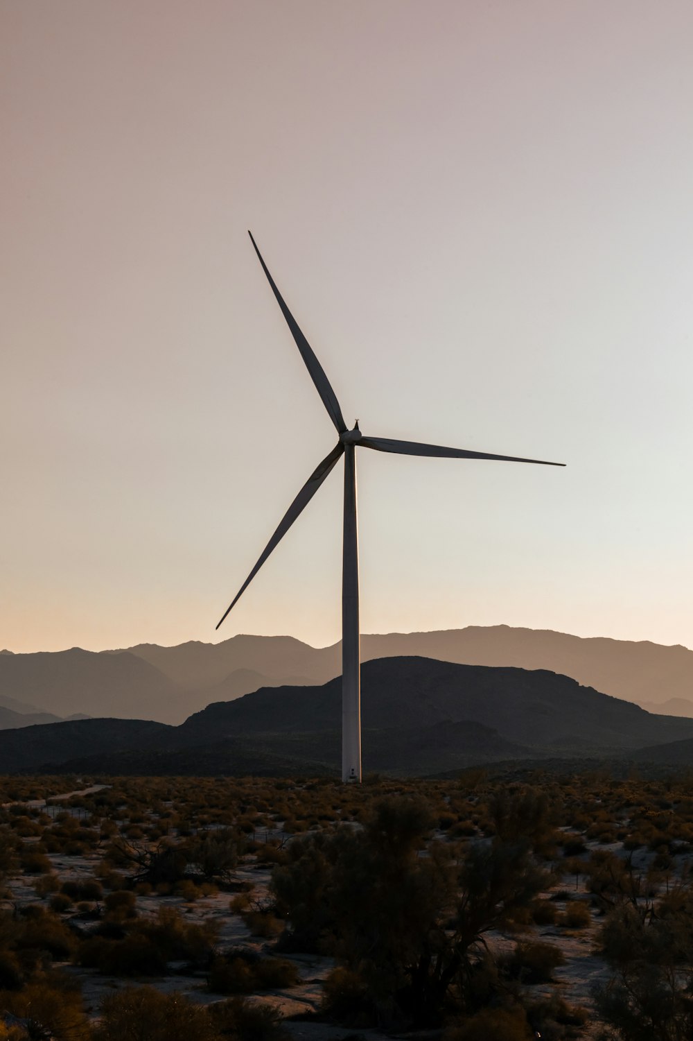 a wind turbine in the middle of a desert