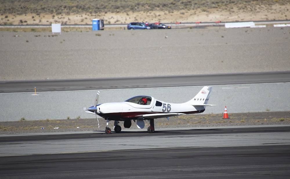 a small white airplane on a run way