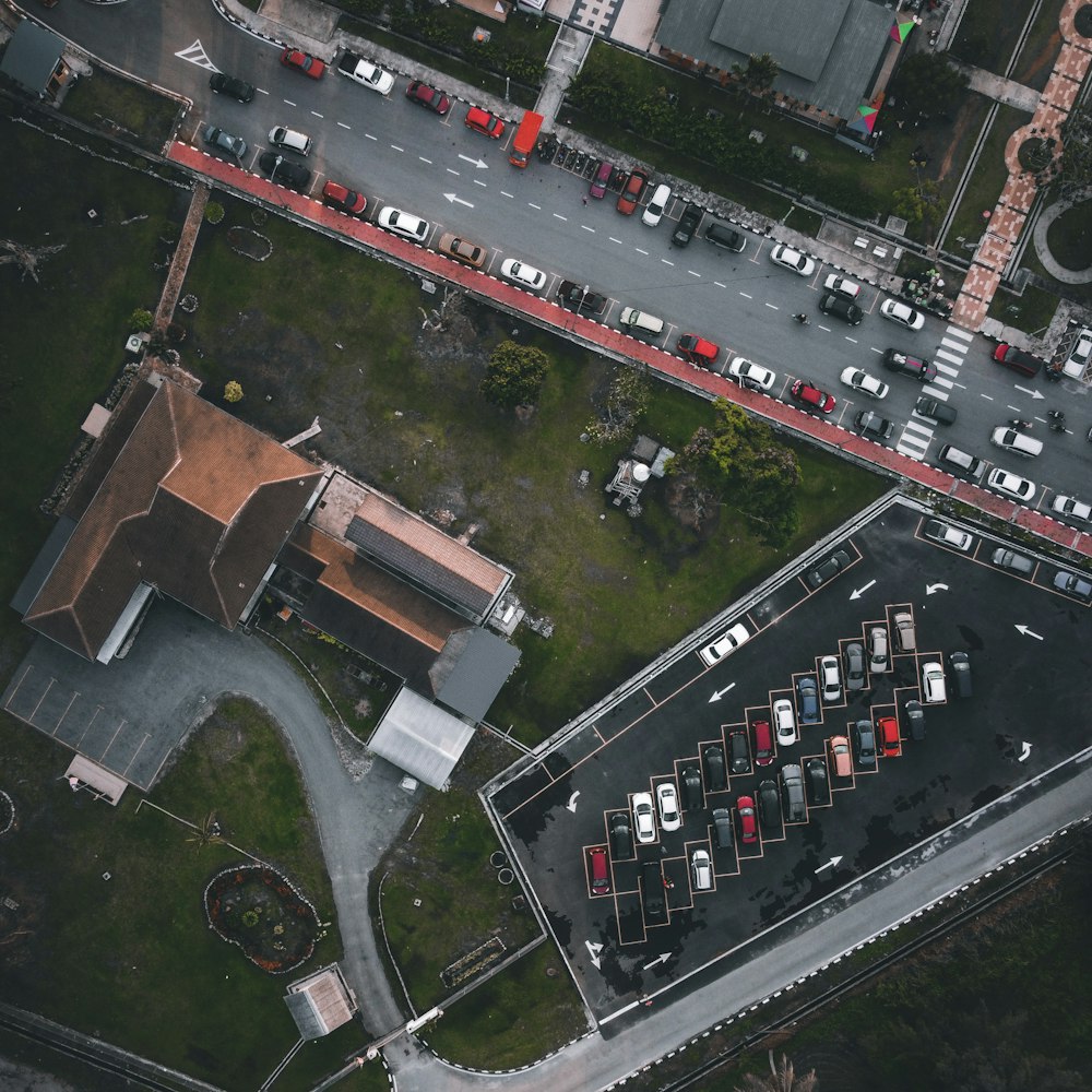 an aerial view of a parking lot with cars parked in it