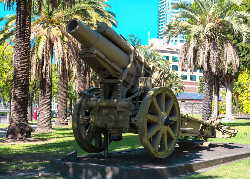 a large metal cannon sitting on top of a cement slab