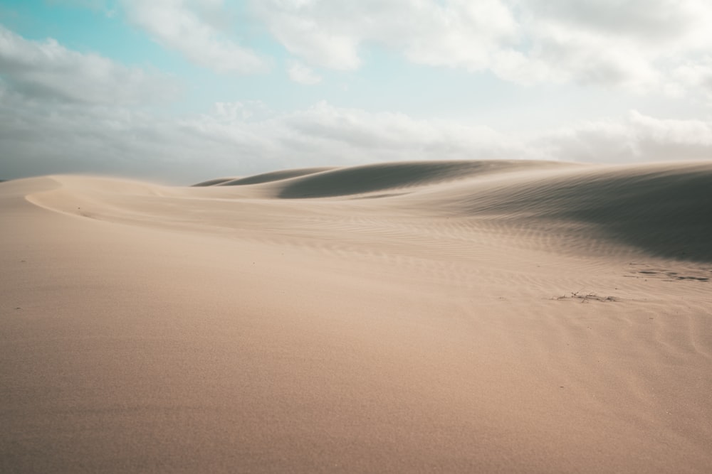 a large sand dune with a sky background