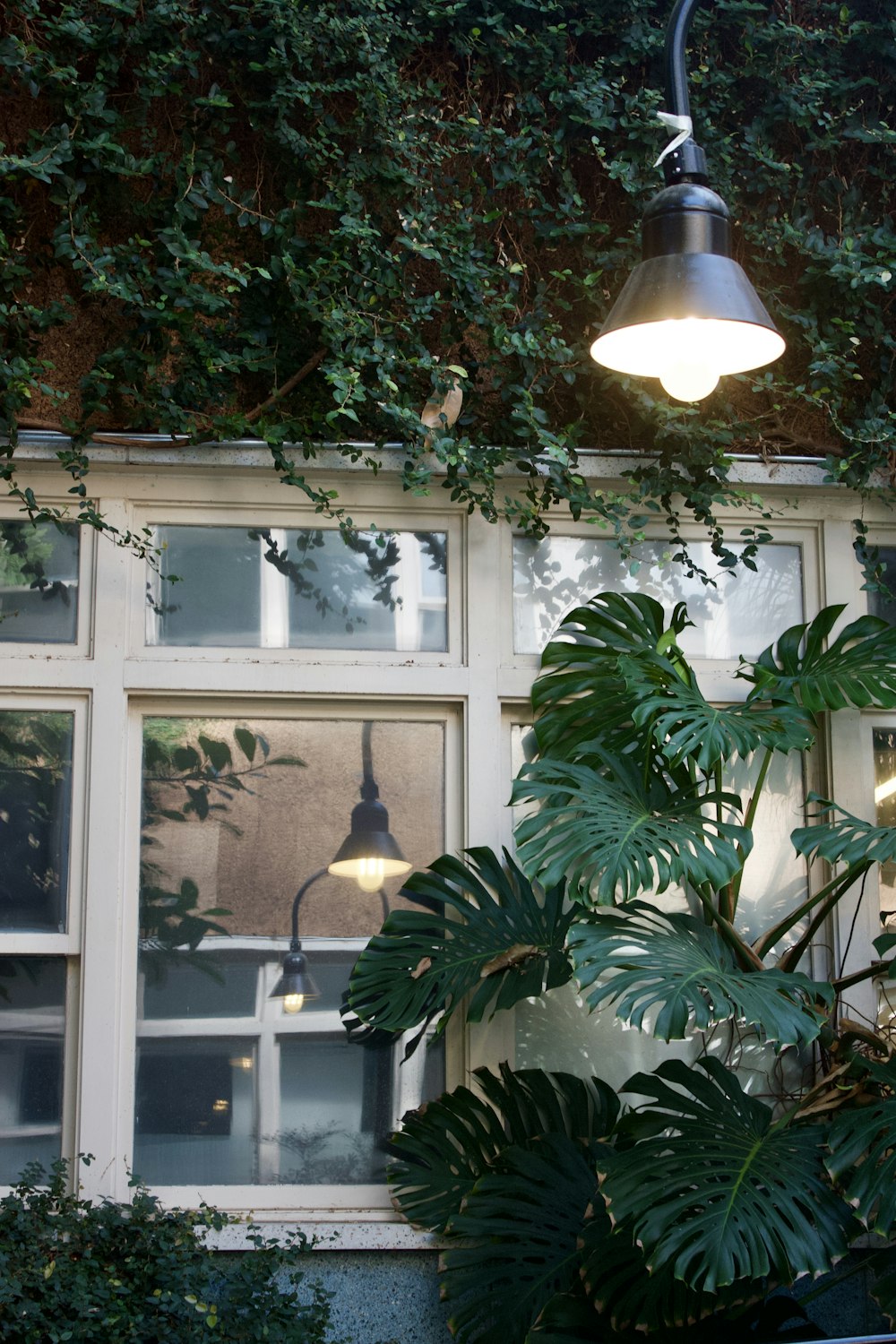 a lamp hanging from a ceiling next to a window