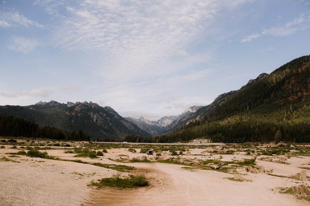 a dirt road in the middle of a mountain range