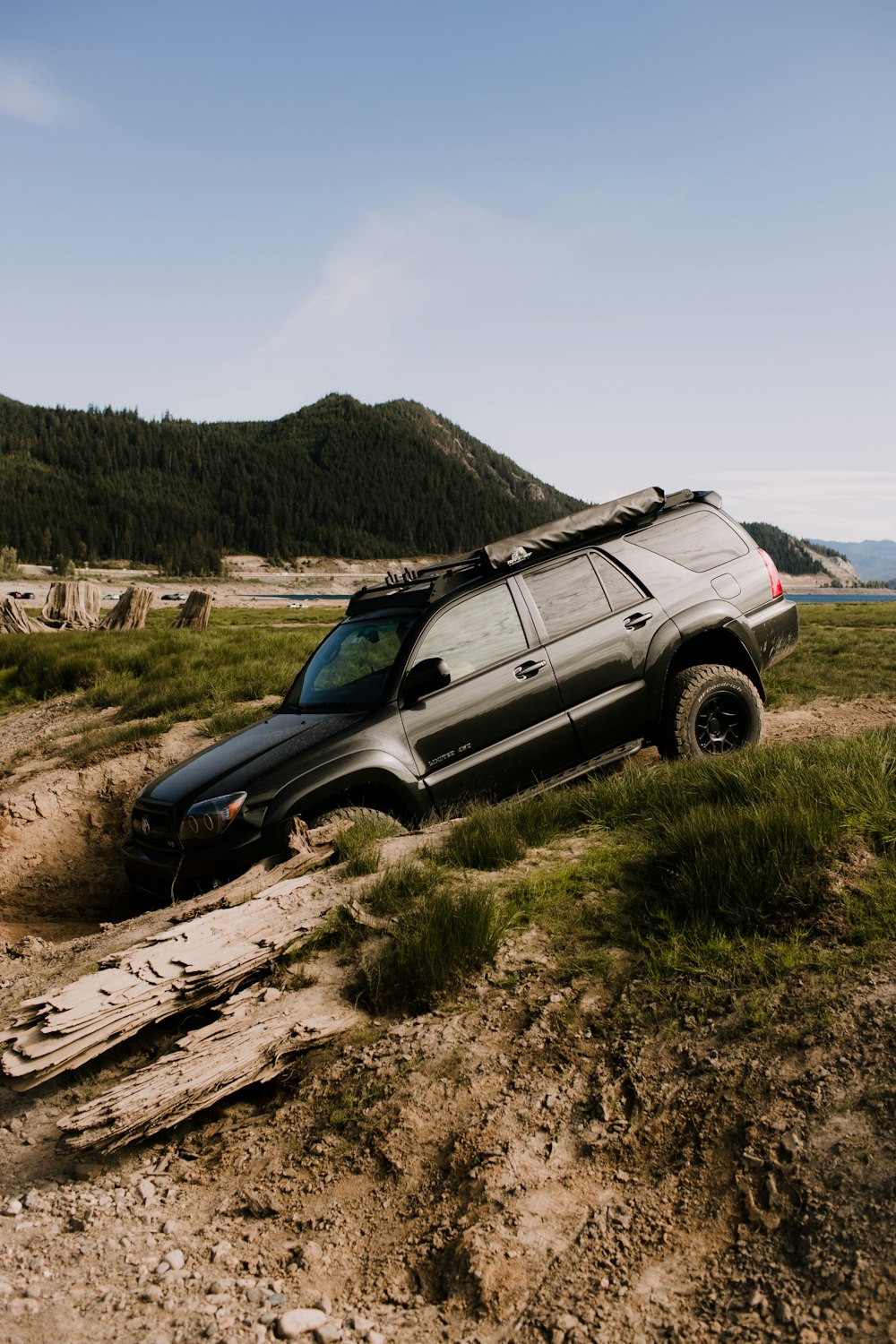 a suv is stuck in the mud on a hill