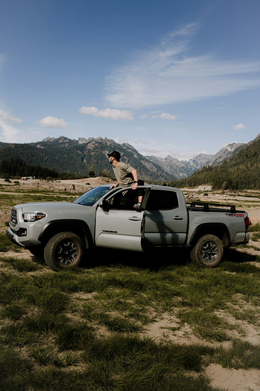 a man standing on the hood of a truck