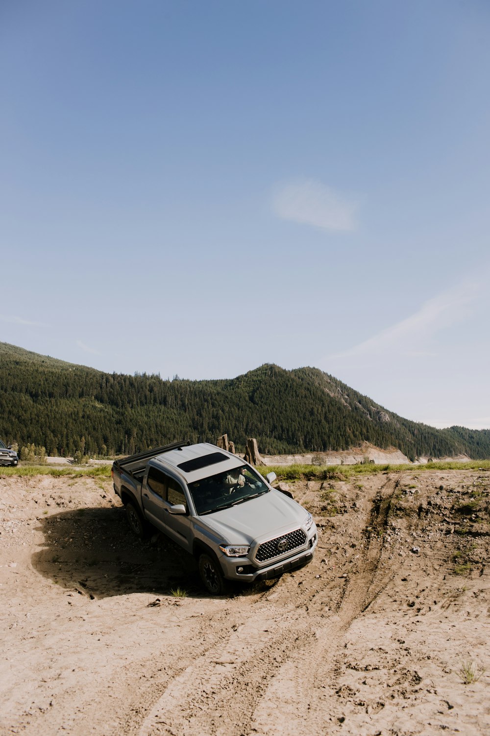 a car parked in the middle of a dirt road