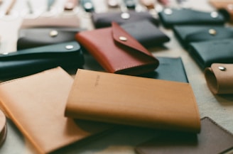 a table topped with lots of different types of wallets