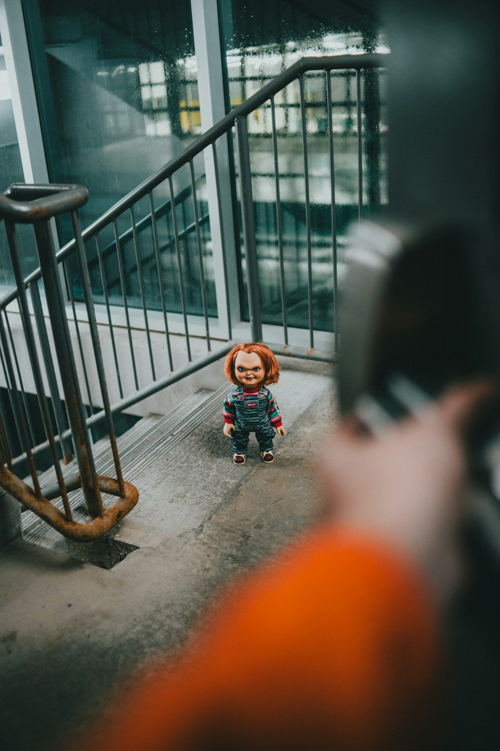 a person taking a picture of a small doll