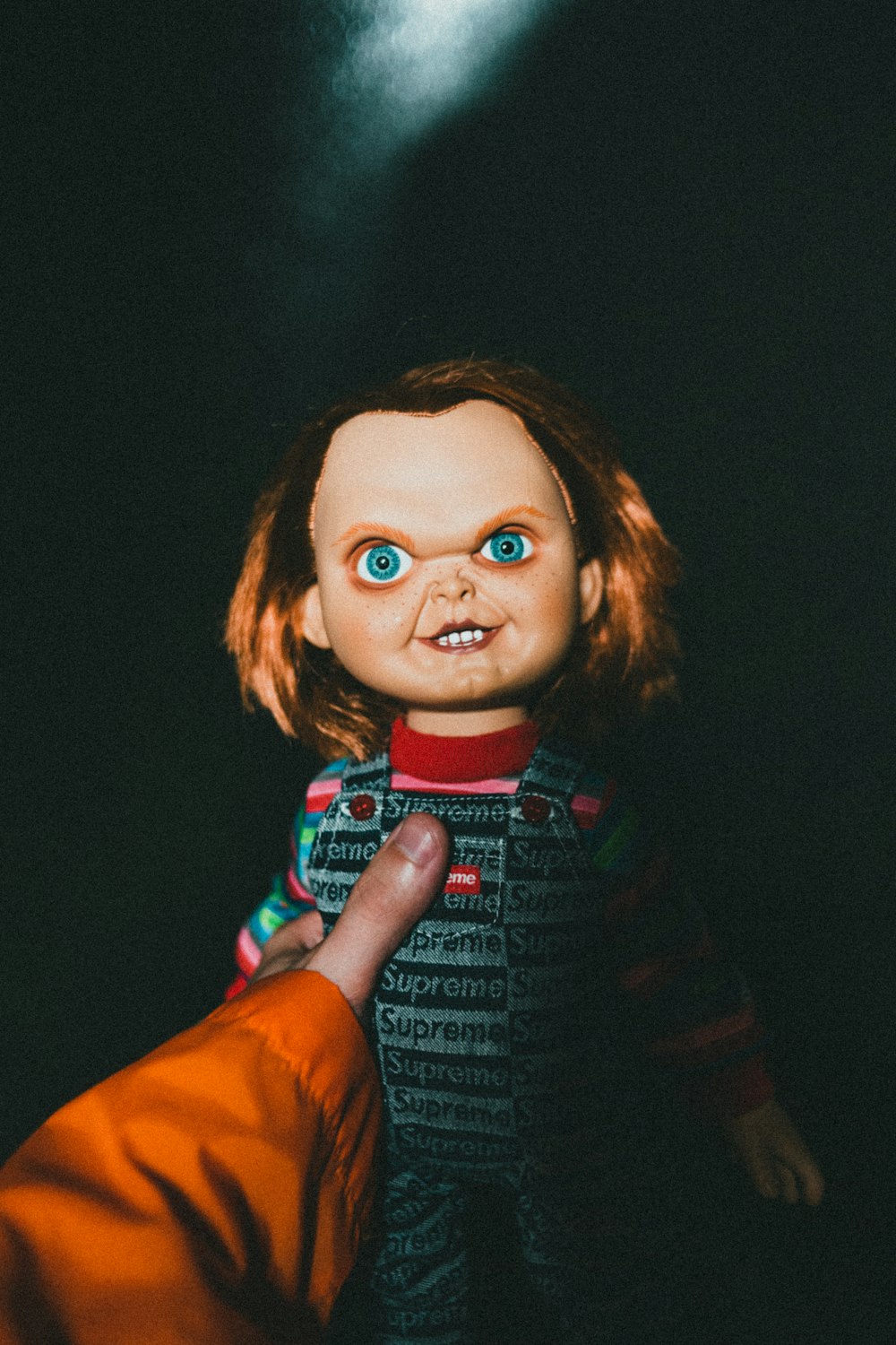a creepy doll being held by a person