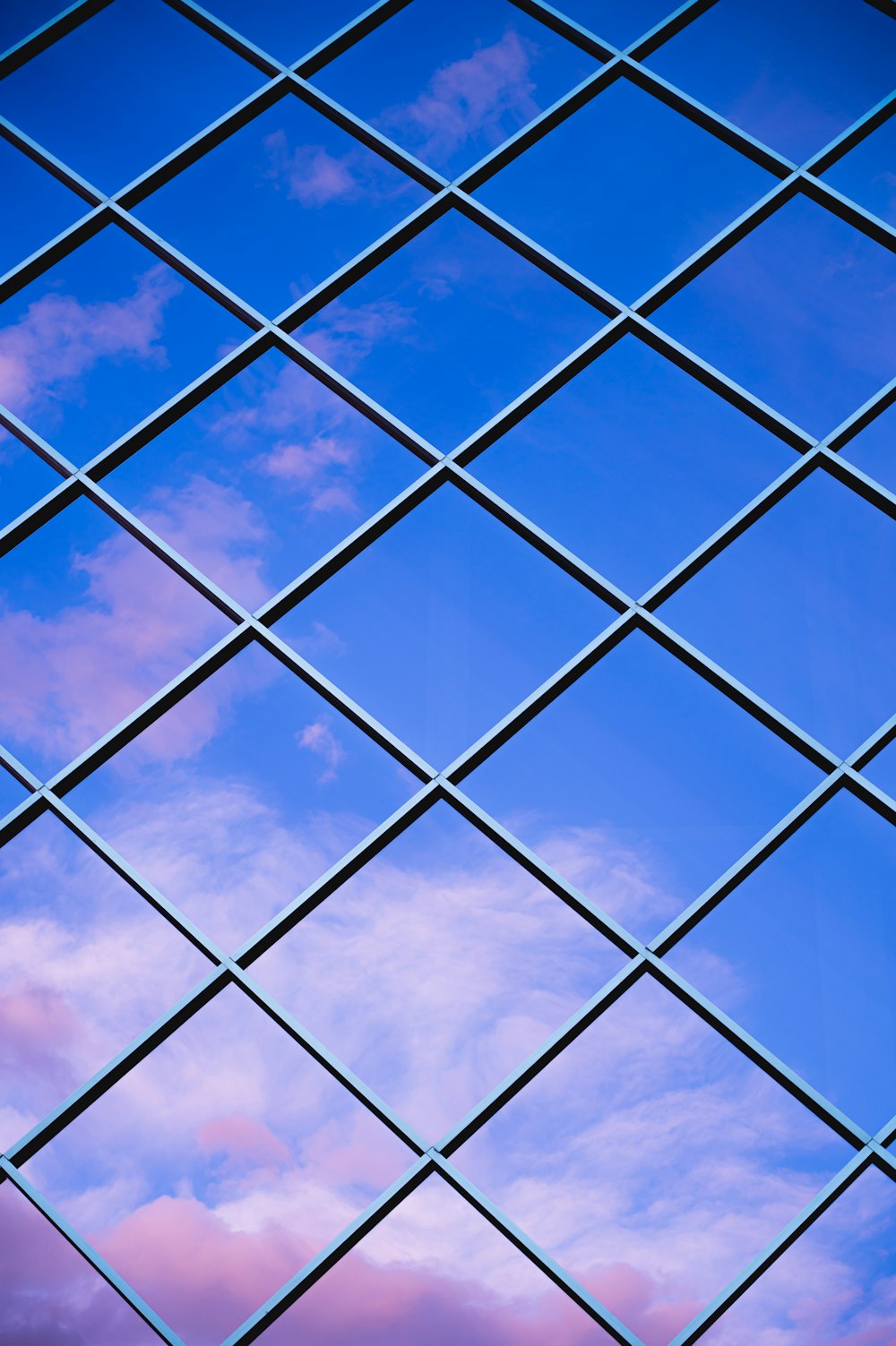 a view of the sky through a metal grid