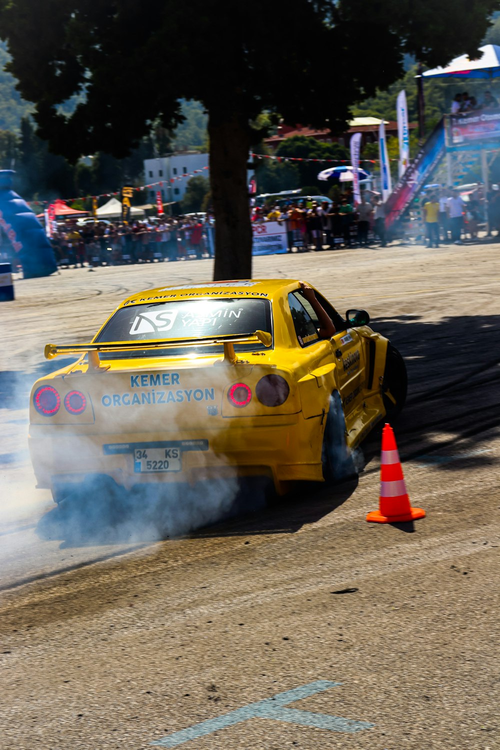 a yellow car with smoke coming out of it