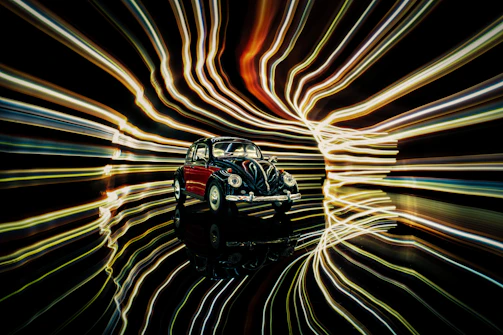 Interactive 3D point-cloud model of a vintage car with glowing edges against a dark background.