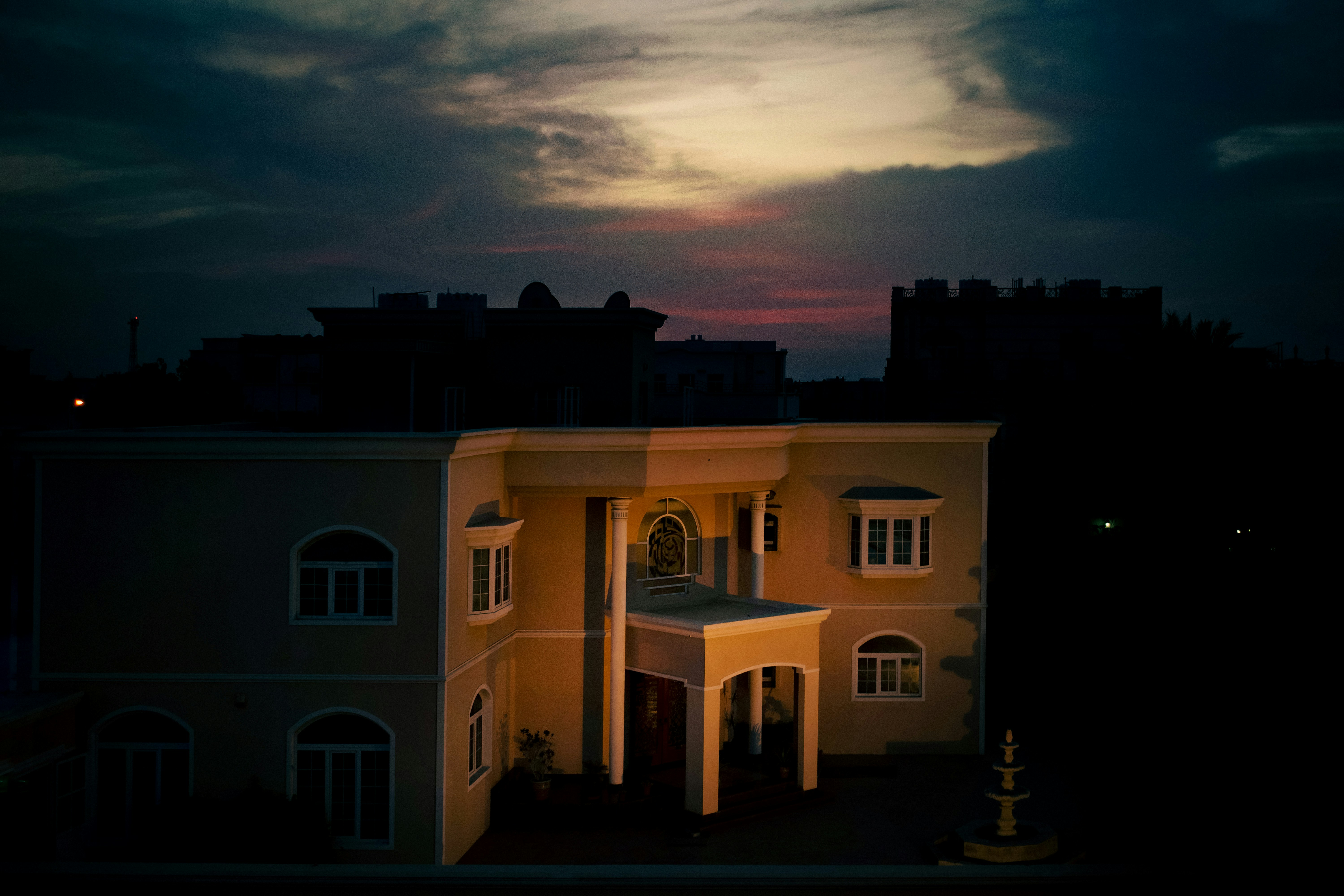 a building with a clock tower in front of a cloudy sky