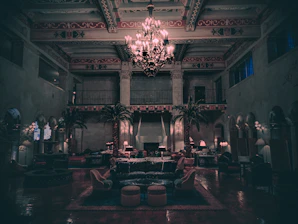 A cinematic frame capturing a luxurious noir interior bathed in dark gradients and golden light reflections.