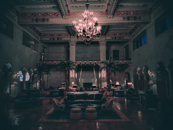 Softly lit image of a serene, luxurious lounge with plush seating and delicate floral accents.