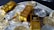 Several gold bars are placed on top of a pile of bitcoin coins and US dollar bills, indicating a scene of wealth and finance.