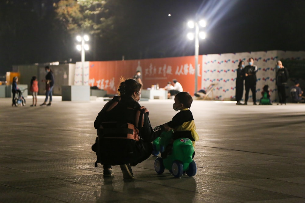 a couple of kids sitting on top of a bench