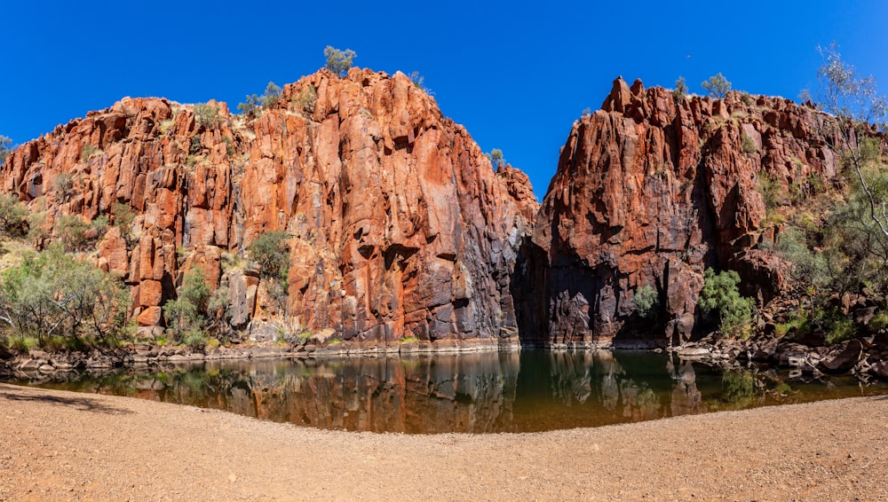 a body of water surrounded by mountains and trees