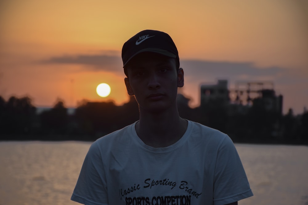 a man standing in front of a body of water