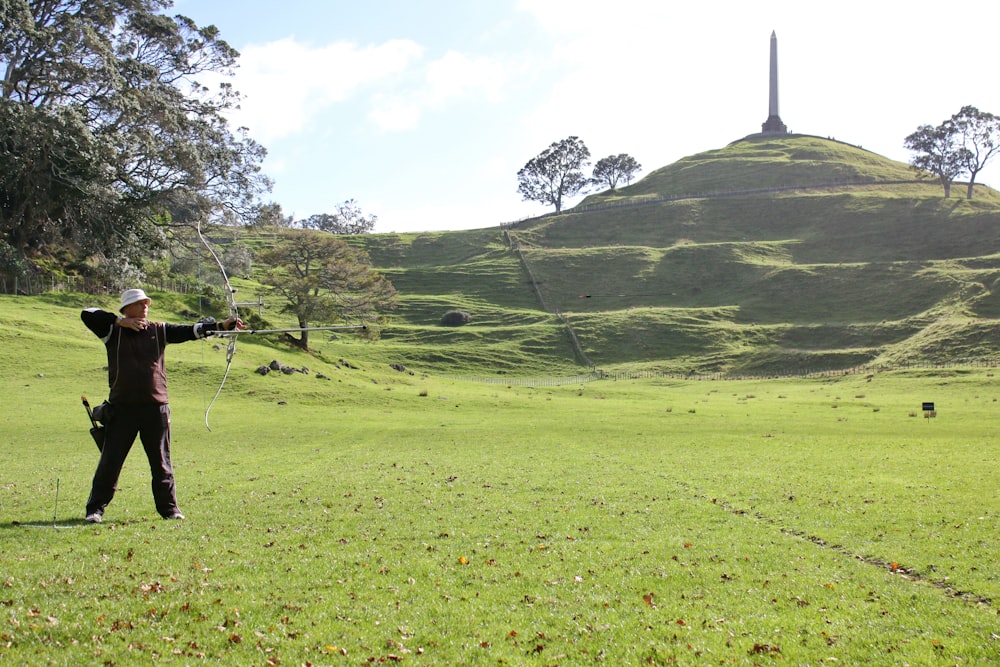 a person standing on a lush green field