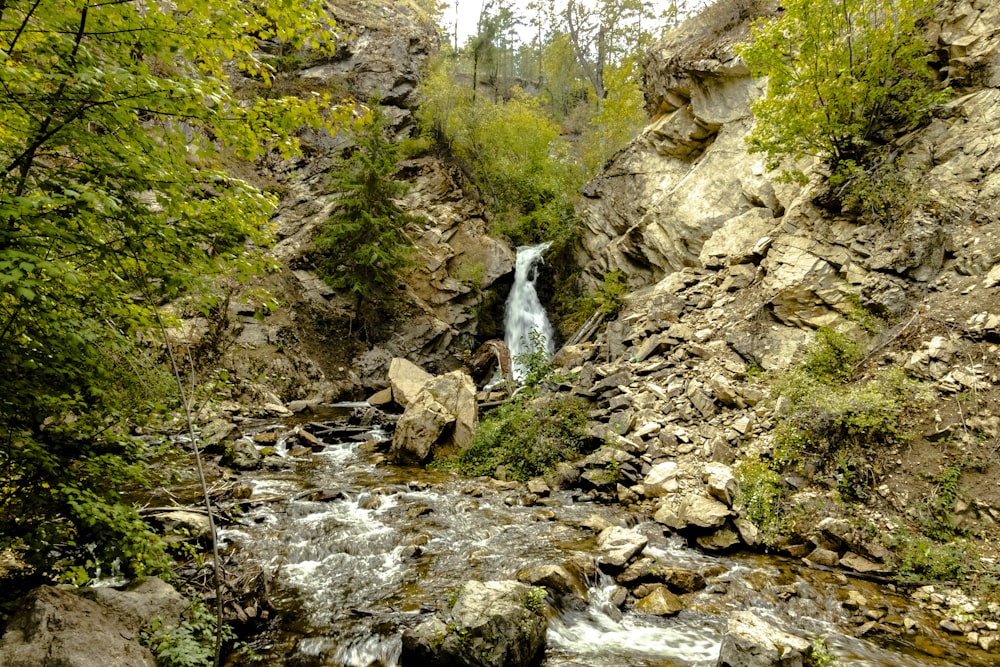 a small waterfall in the middle of a rocky area