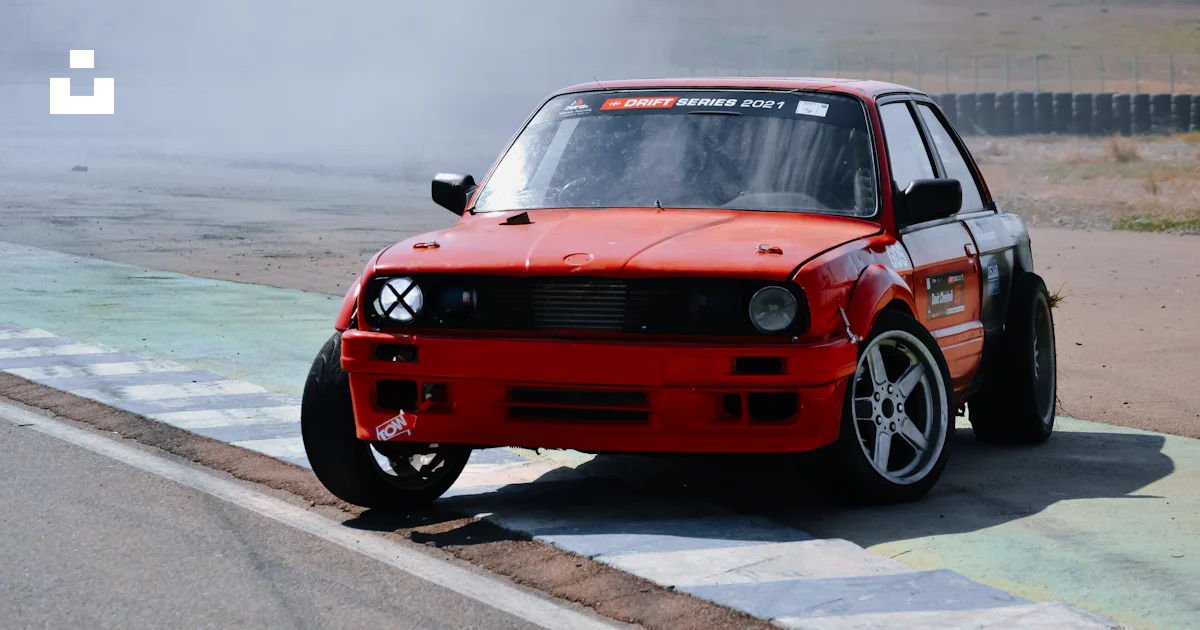 A red car driving down a race track photo – Free Rustavi international ...