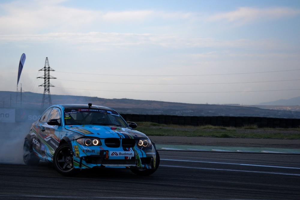 a blue car with smoke coming out of it