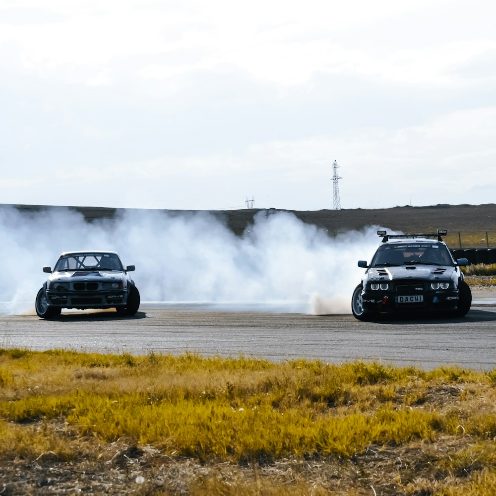 a couple of cars driving down a road next to each other