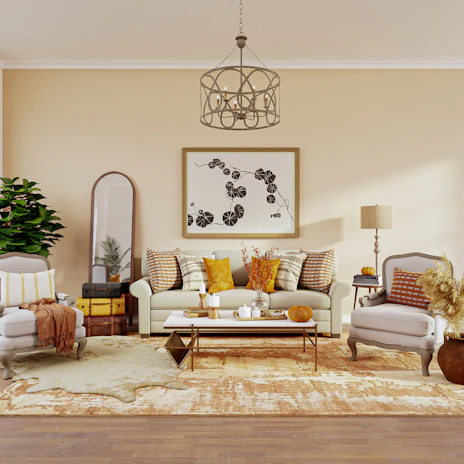 A warm, inviting living room corner styled with soft cream and clay accents.