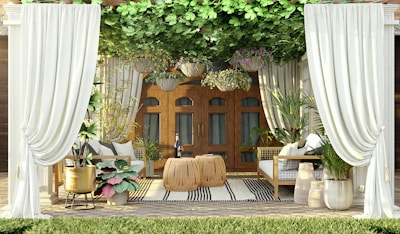 Outdoor pergola with stylish curtains and comfortable seating