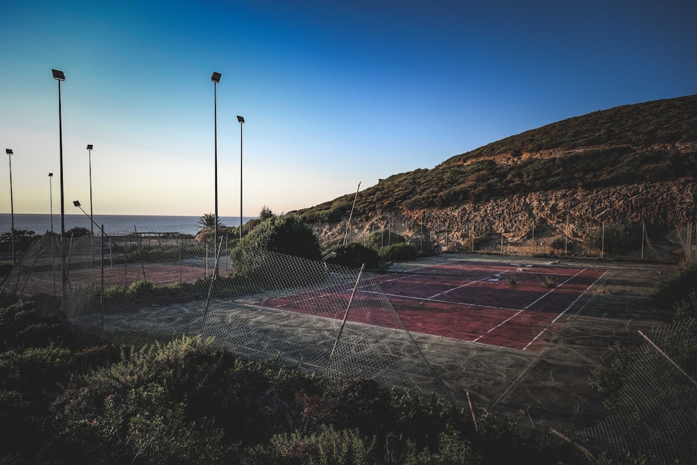 a tennis court in front of a mountain