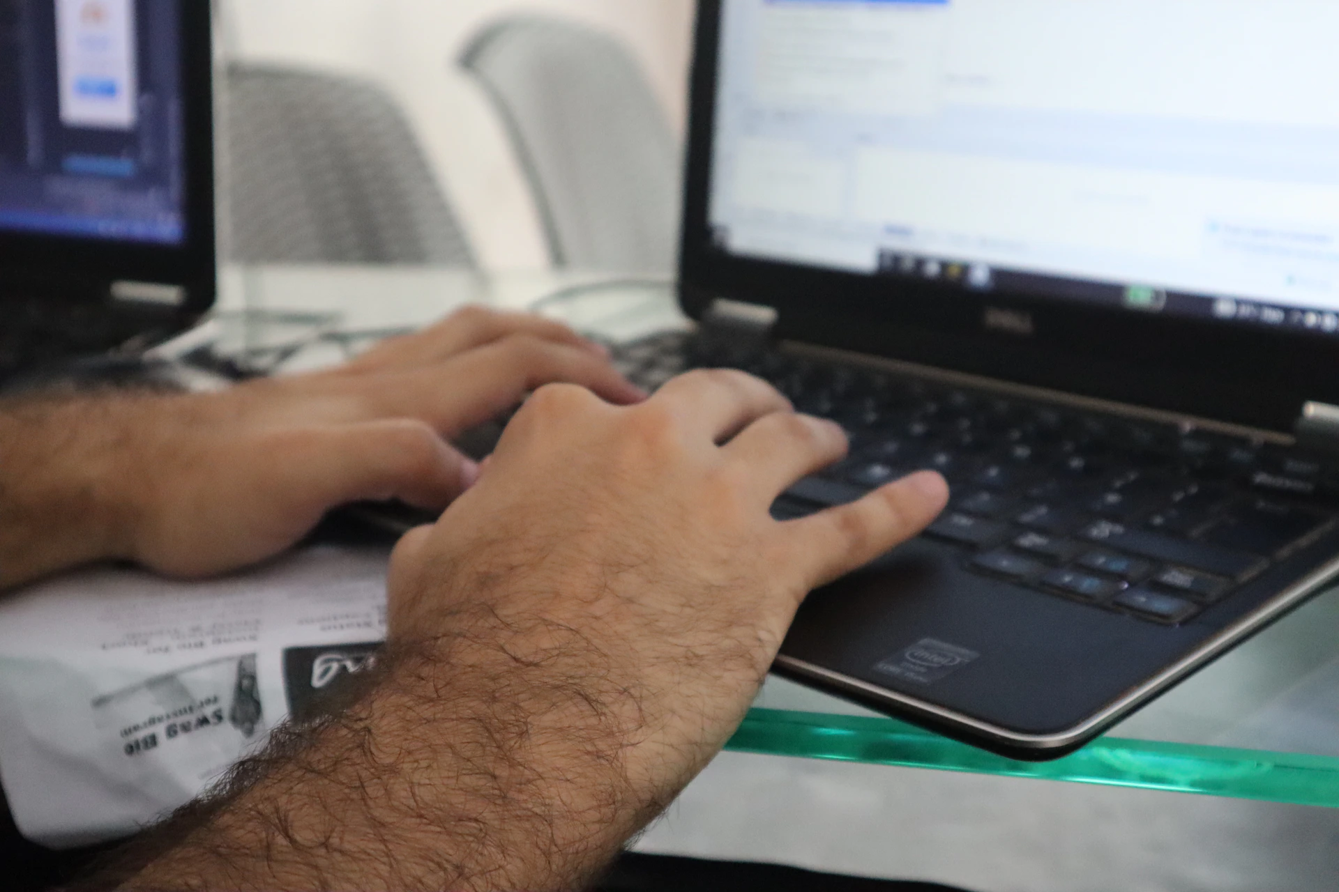 a man is typing on a laptop computer