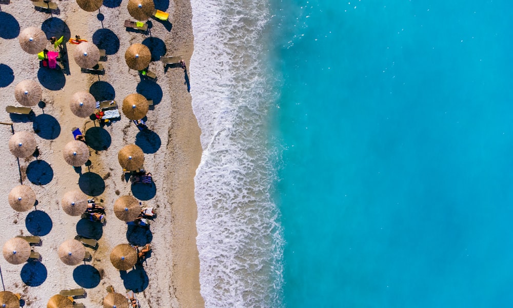 an aerial view of a beach with umbrellas and people