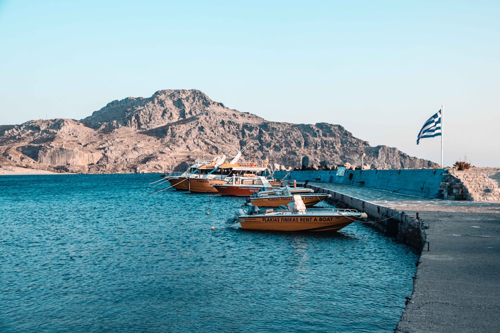 a group of boats sitting on top of a body of water