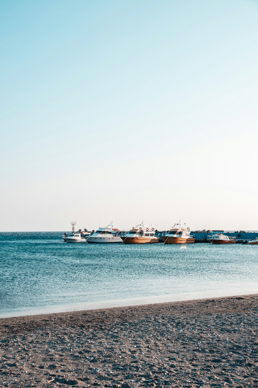 a group of boats floating on top of a body of water