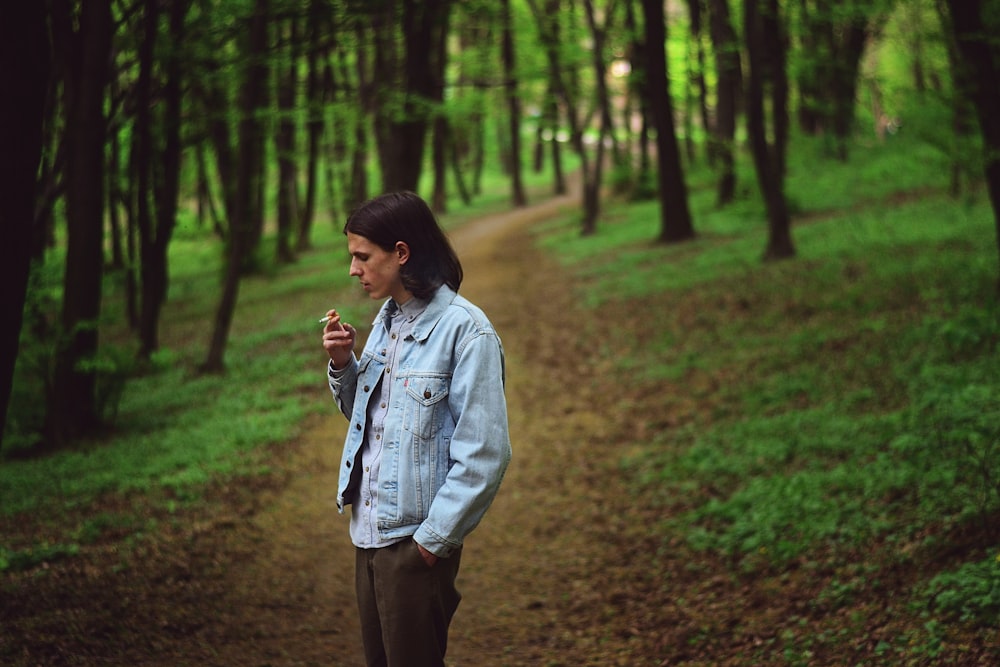 a man standing in the middle of a forest