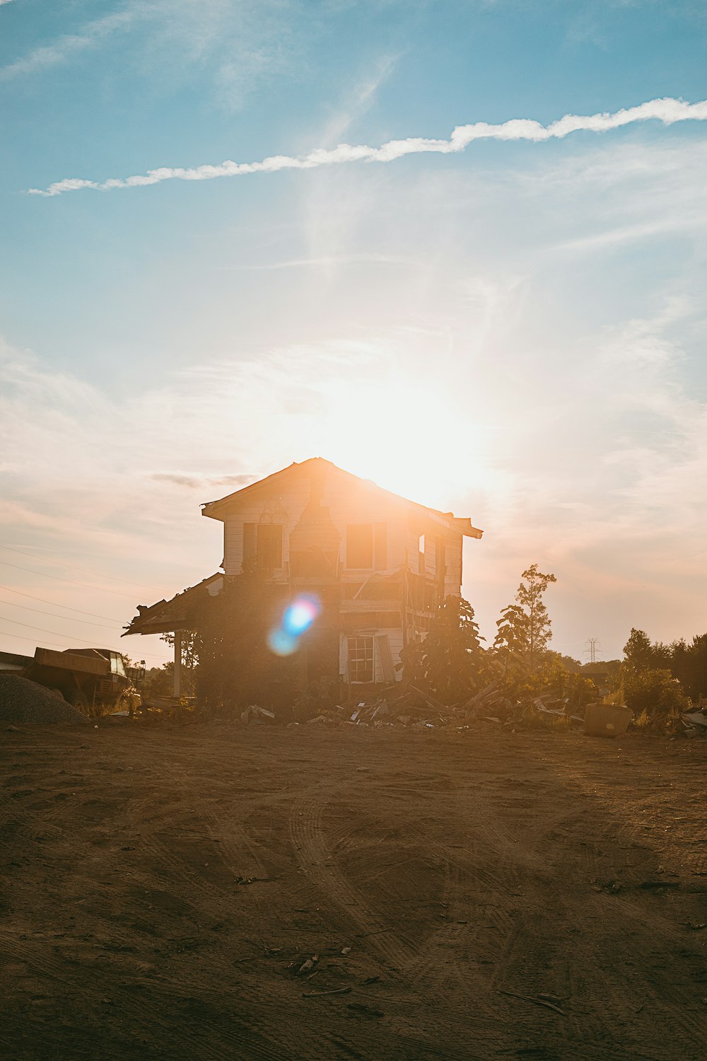 a large house sitting on top of a dirt field