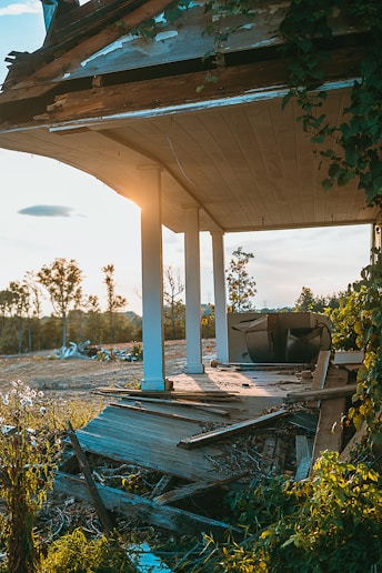 a wooden bench sitting under a wooden roof